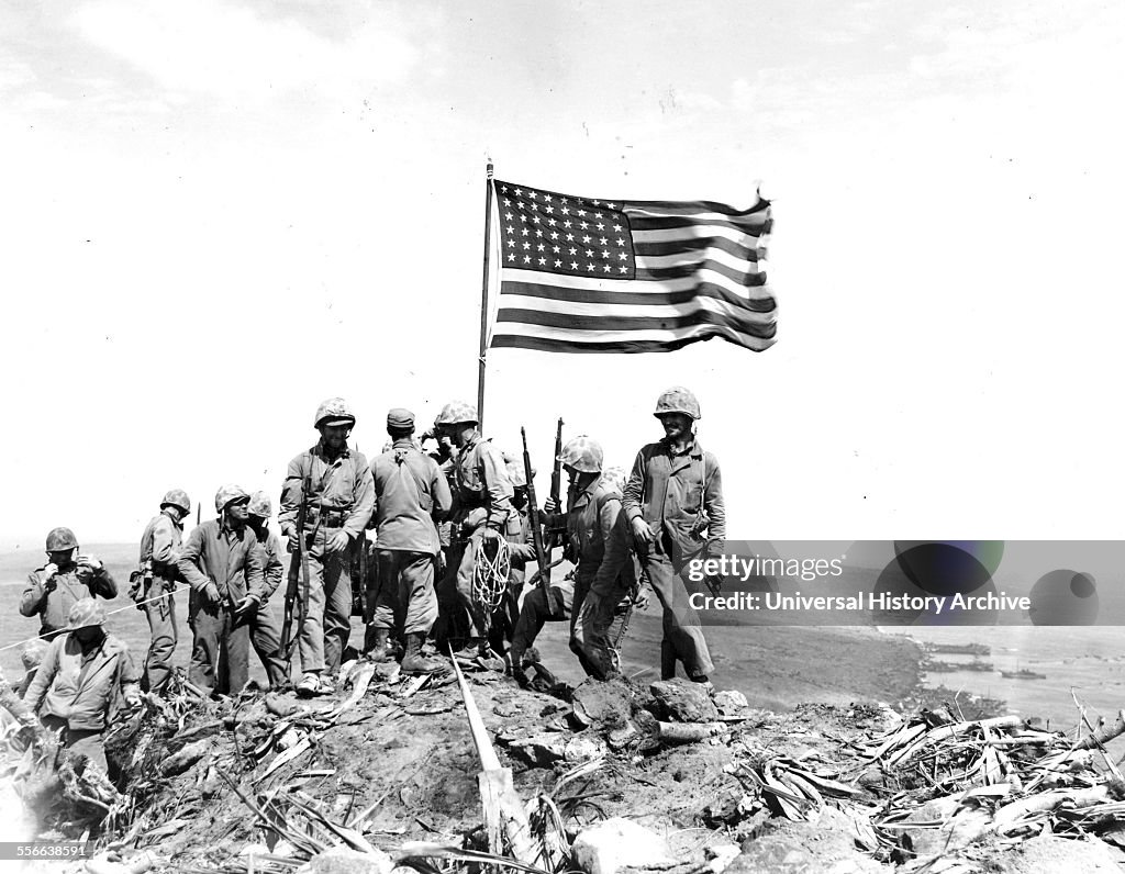 Battle of Iwo Jima. Photo taken during flag raising on volcano top.