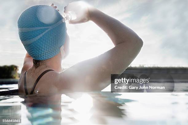female swimmer in pool, early morning. - one mature woman only stock pictures, royalty-free photos & images