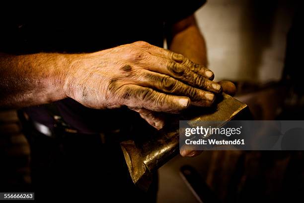blacksmith holding workpiece - artisan hands stock pictures, royalty-free photos & images