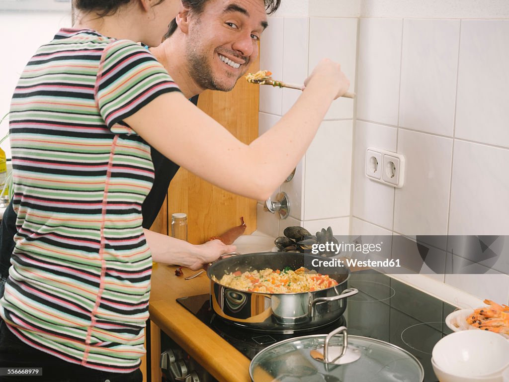 Couple trying freshly cooked paella