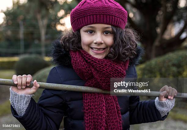 portrait of smiling little girl wearing wool cap and scarf - girl scarf bildbanksfoton och bilder