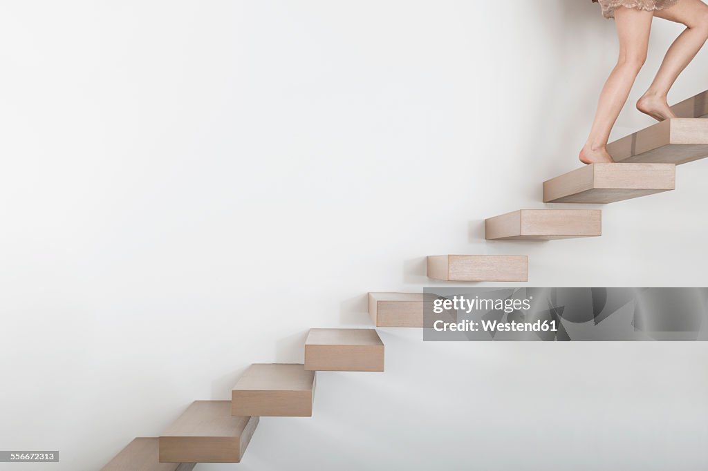 Woman walking on floating staircase