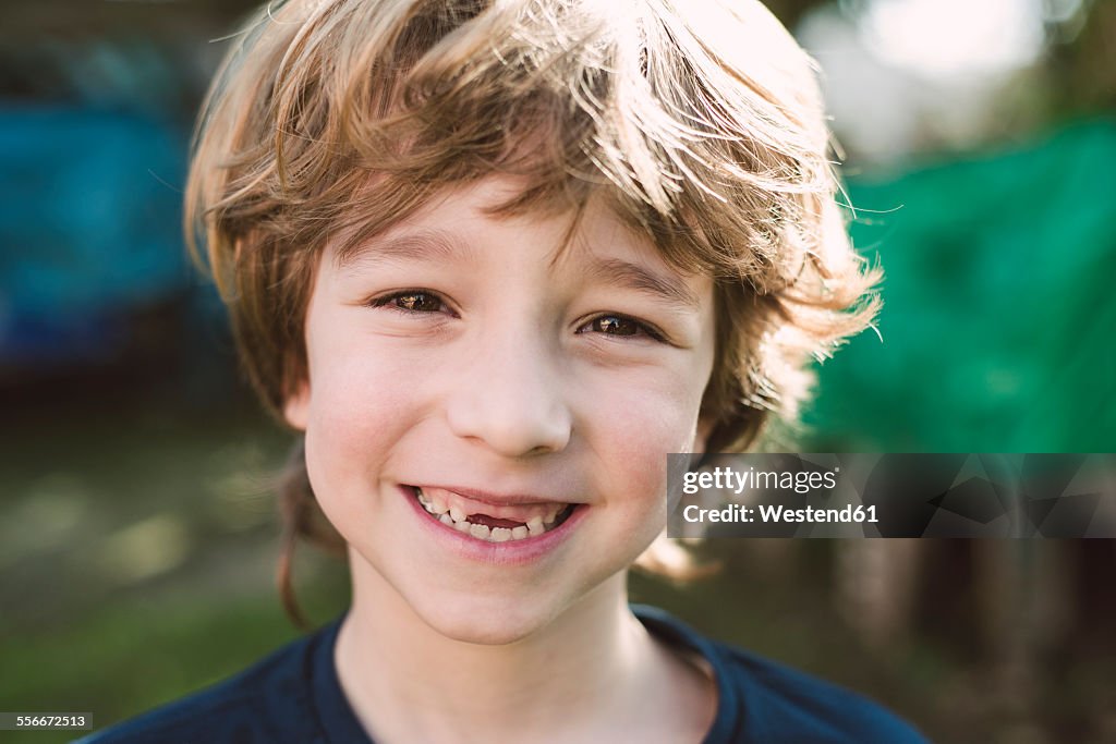 Portrait of blond boy with a big smile