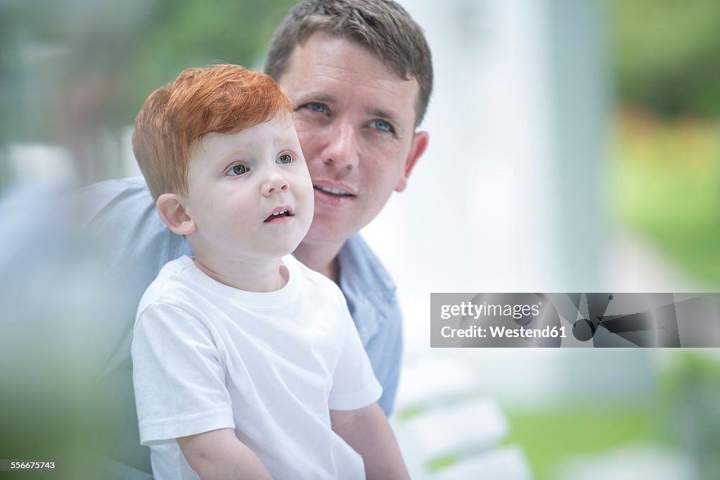 Red-haired boy with father outside