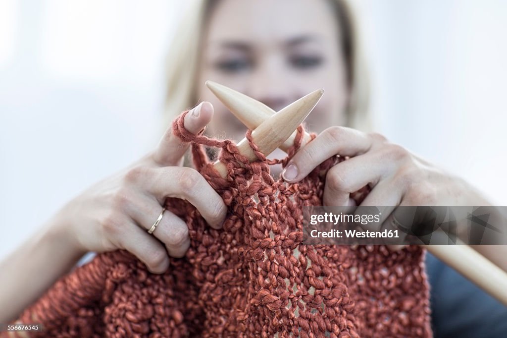 Close-up of woman knitting a blanket