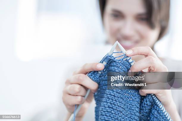 close-up of woman knitting a blanket - stricknadel stock-fotos und bilder