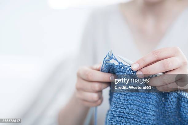 close-up of woman knitting a blanket - stricknadel stock-fotos und bilder