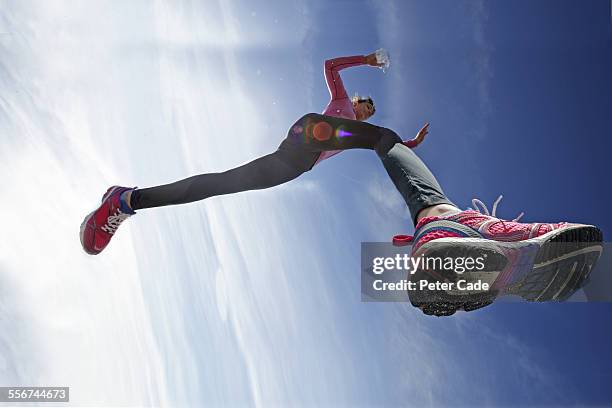 woman jumping in the air, sport , trainers - vista de ángulo bajo fotografías e imágenes de stock