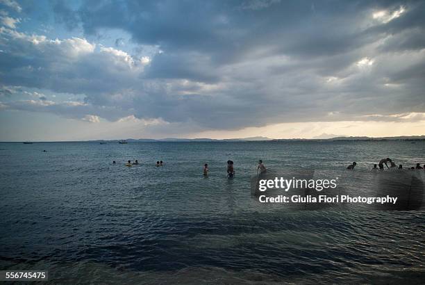 people bathing in the sea in hammamet - hammamet beach stock pictures, royalty-free photos & images