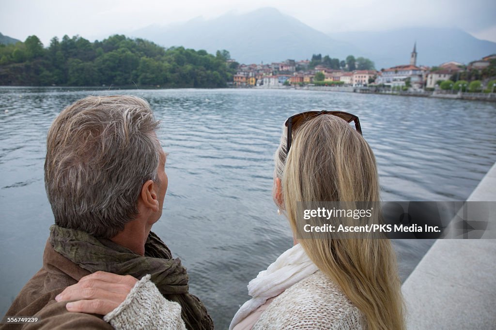 View past mature couple to lakeside village