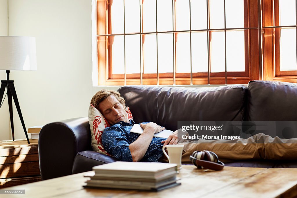 Man sleeping on sofa at home