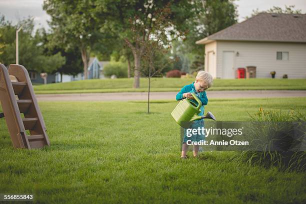 little boy with watering can - annie sprinkle stock pictures, royalty-free photos & images