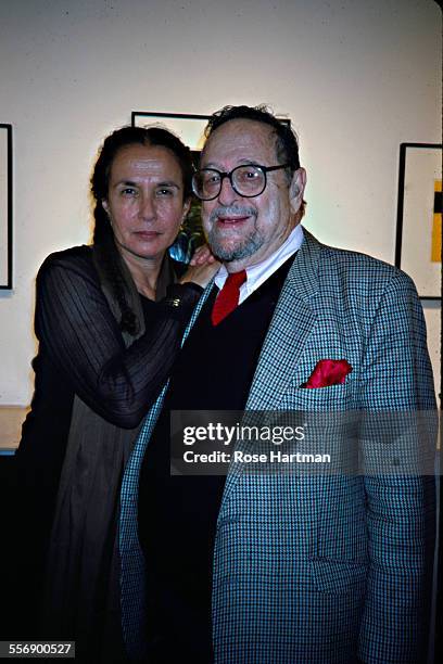 Portrait of American photographers Mary Ellen Mark and Arnold Newman as they attend a gallery show in Soho, New York, New York, 2002.