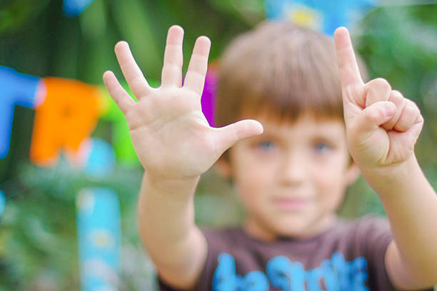 Birthday boy showing the number six with his hands