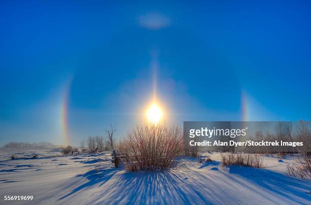 high dynamic range photo of sundogs and a solar halo around the sun. - optical phenomenon halo stock pictures, royalty-free photos & images