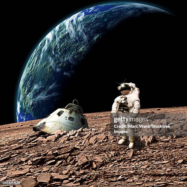 an astronaut surveys his situation after being marooned on a barren planet. an earth-like planet shines in the background. - planets colliding stock pictures, royalty-free photos & images