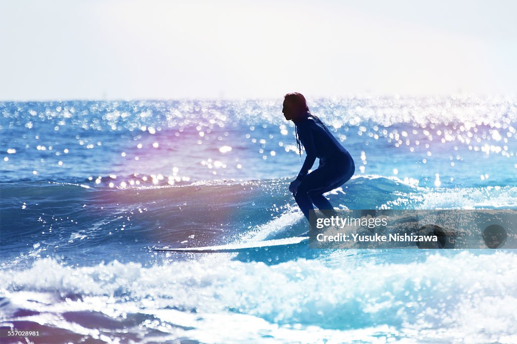 Female surfer riding the wave
