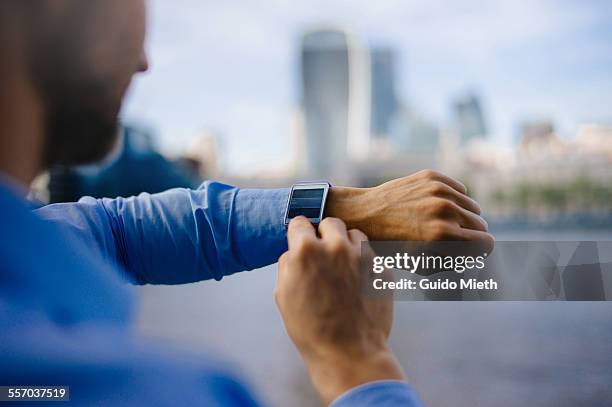 businessman using smartwatch. - homem de azul imagens e fotografias de stock