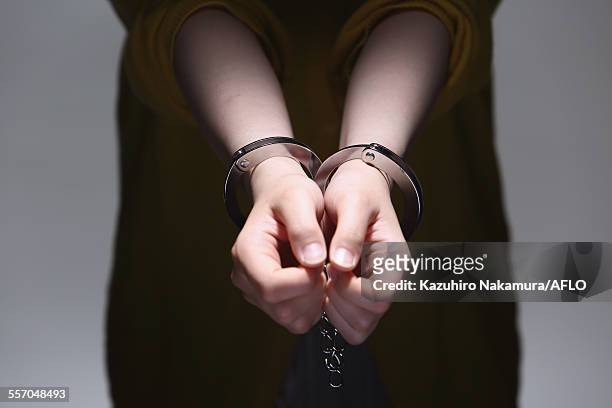 handcuffed arms - cuff stock pictures, royalty-free photos & images