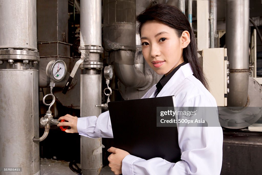 Female Technician Operating the Machine