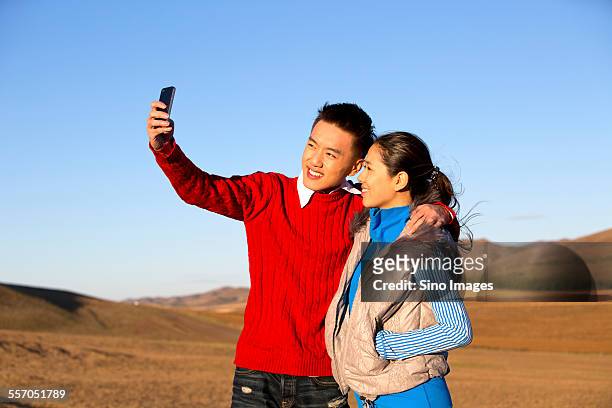 young couple on vacation - men selfie wide stock pictures, royalty-free photos & images