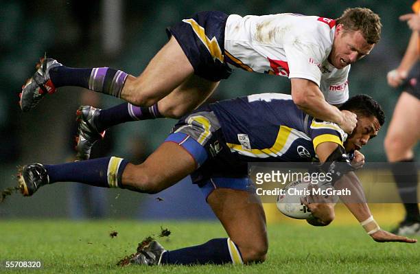 Matt Orford of the Stoprm tackles David Faiumu of the Cowboys during the NRL Semi Final between the Melbourne Storm and the North Queensland Cowboys...