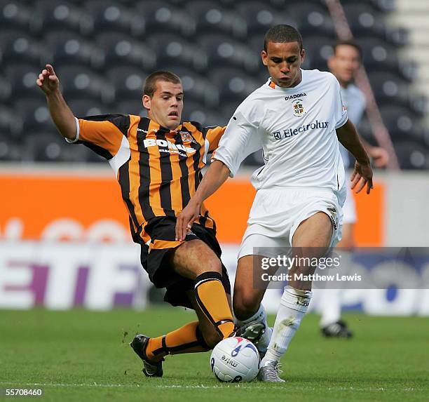 John Welsh of Hull tackles Dean Morgan of Luton during the Coca-Cola Championship match between Hull City and Luton Town at the KC Stadium on...
