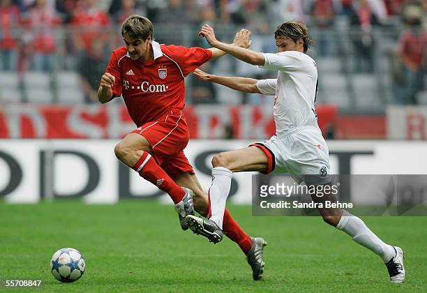 Sebastian Deisler of Bayern Munich challenges Thomas Brdaric of Hanover 96 during the Bundesliga match between Bayern Munich and Hanover 96 at the...