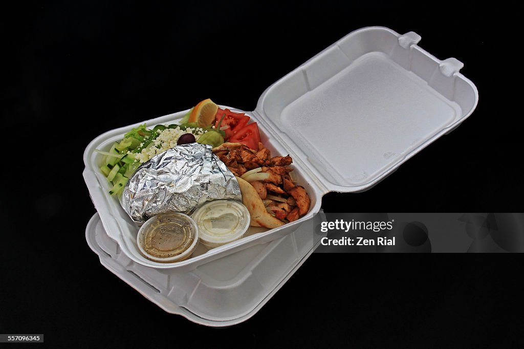 Take out chicken gyro on black background