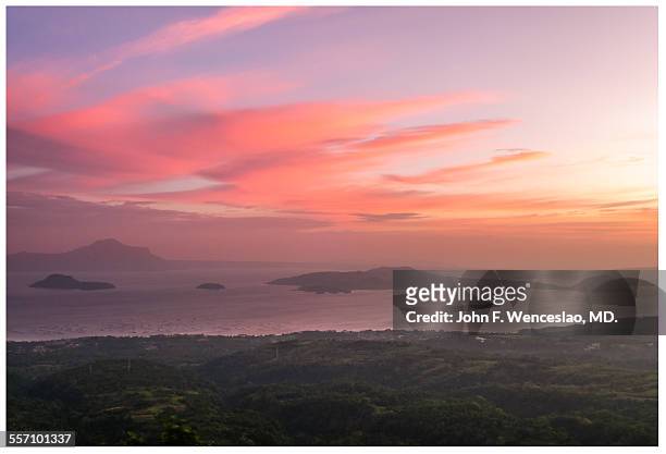 sunset over taal lake - tagaytay stock pictures, royalty-free photos & images