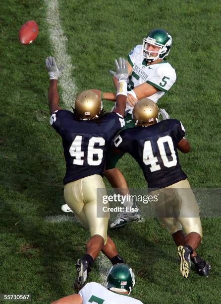 Quarterback Drew Stanton of the Michigan State Spartans is pressured by linebackers Corey Mays and Maurice Crum Jr. #40 of the Notre Dame Fighting...