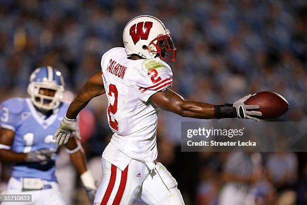 Brian Calhoun of the Wisconsin Badgers celebrates a touchdown as Cedric Holt of the North Carolina Tar Heels watches, on September 17, 2005 at Kenan...