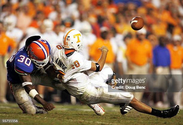 Quarterback Erik Ainge of the Tennessee Volunteers is brought down by linebacker Earl Everett of the Florida Gators while attempting a pass in the...