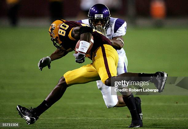 Derek Hagan of the Arizona State Sun Devils runs with the ball as Marquice Cole of the Northwestern Wildcats tries to block him during the second...