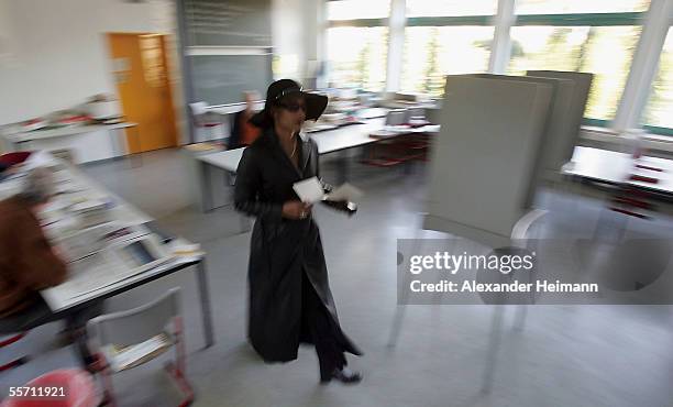 Voter rushes into a polling booth in a polling station, to vote in the German Bundestag elections on September 18, 2005 in Gross Gerau, Germany.