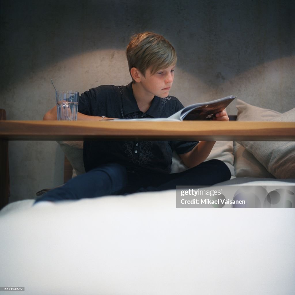 Young Boy Reading at Table