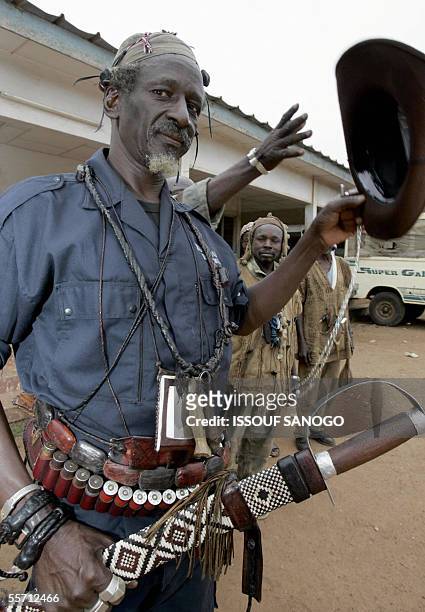 Dozo chief, traditional hunter, fighting alongside former opposition rebel New Forces, stands with his men 18 September 2005 in the northern Ivorian...
