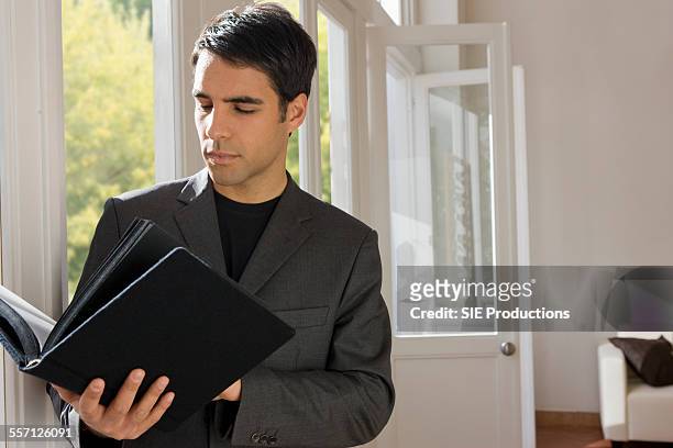 man holding binder - sie productions foto e immagini stock
