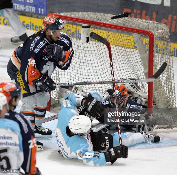 Stefan Ustorf and Daniar Dshunssow of Eisbaeren compete with Paul Manning of Freezers during the DEL match between Eisbaeren Berlin and Hamburg...