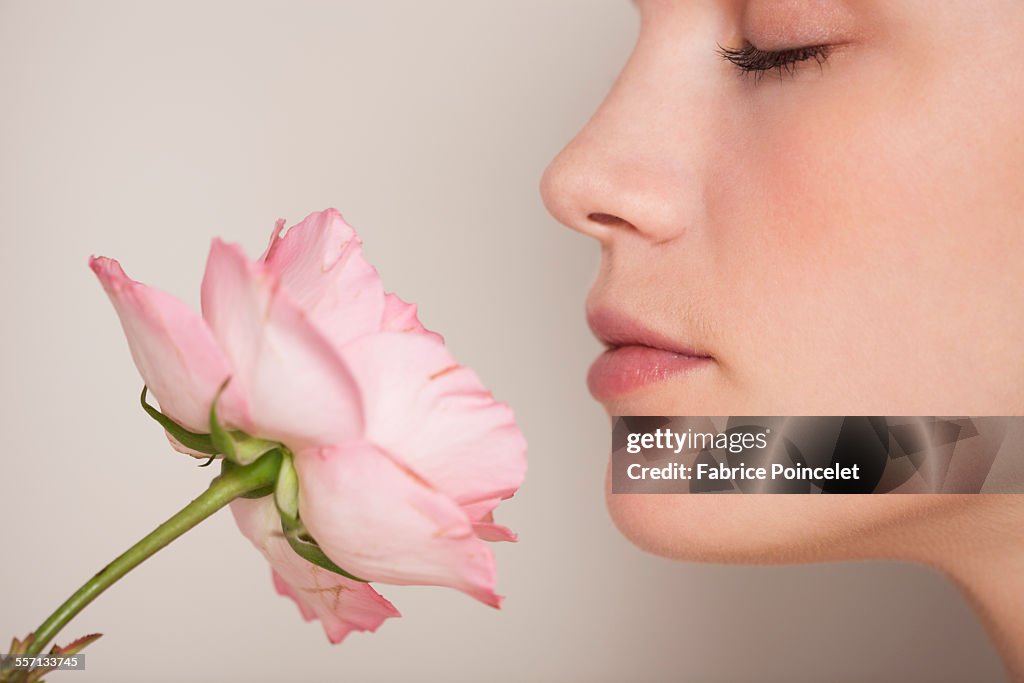 Beautiful woman smelling a flower