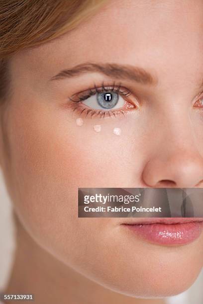 beautiful woman applying concealer - concealer stock pictures, royalty-free photos & images