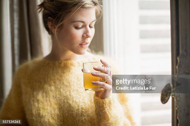 woman drinking herbal tea - ハーブティー ストックフォトと画像