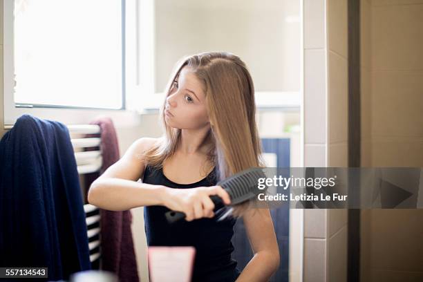 teenage girl getting hair care with brush - combing ストックフォトと画像