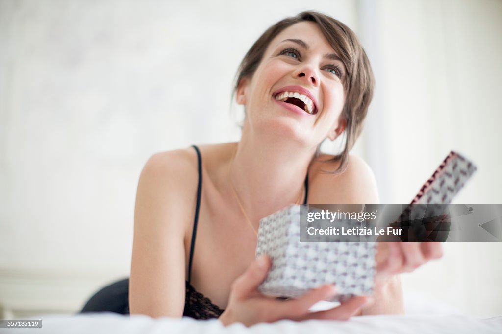 Beautiful happy woman holding a gift box
