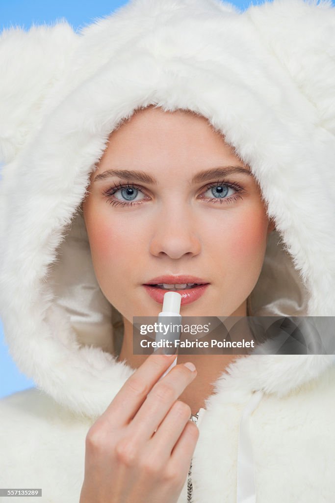 Female applying lip balm on her lips