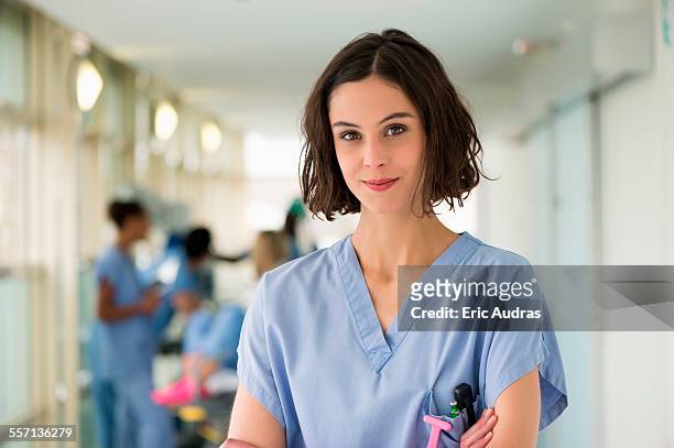 portrait of a female nurse with her arms crossed - female nurse stock pictures, royalty-free photos & images