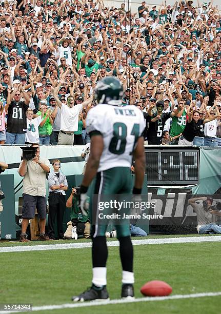 Fans cheer as Terrell Owens of the Philadelphia Eagles stands on the goal line after catching a pass for a touchdown against the San Francisco 49ers...