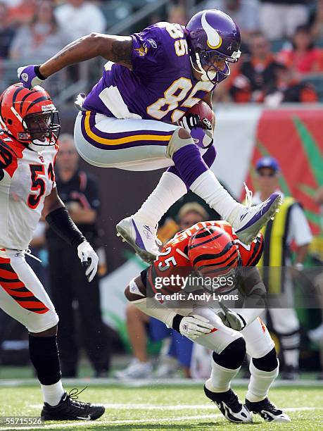 Jermaine Wiggins of the Minnesota Vikings jumps over Keiwan Ratliff of the Cincinnati Bengals during the NFL game at Paul Brown Stadium on September...