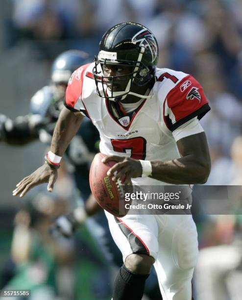 Quarterback Michael Vick of the Atlanta Falcons scrambles against the Seattle Seahawks at Qwest Field on September 18, 2005 in Seattle, Washington.