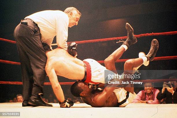 American featherweight boxer Augie Pantellas falls on top of his unidentified opponent during a bout at the Philadelphia Arena, Philadelphia,...